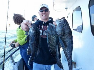 This Ocean Explorer angler shows off his sea bass.