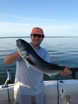 Gideon with a bluefish trolled up on a white reliable spoon.
