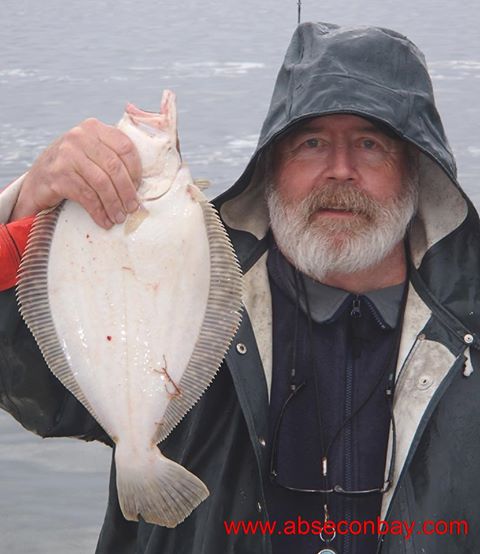 Captain John Fish with a nice flounder on a Rainy Day. Photo courtesy ofAbsecon Bay Sportsmen's Center Facebook page