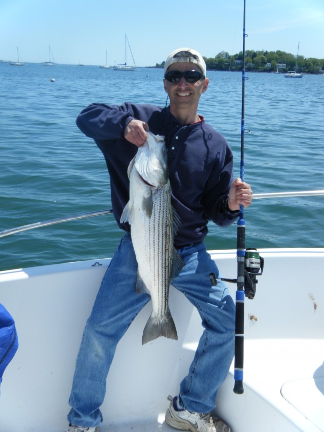Gary George holds up his first keeper bass of 2013, caught on the North Shore of Massachusetts. 