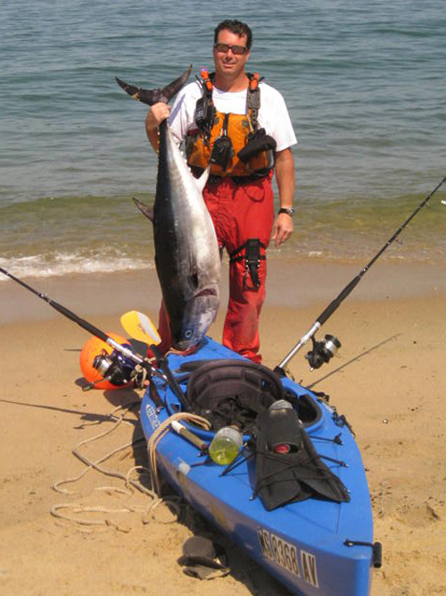 On the front of Lamoureux&rsquo;s 12-foot kayak, he straps a pair of dive fins to serve as the last resort in case of emergency.