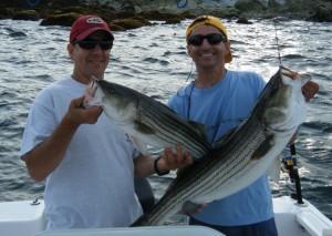 Dean Machado and Gary George with a double hookup of keeper stripers caught on the North Shore.