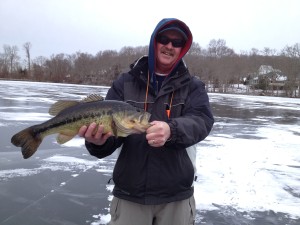 Jim Martin of Portsmouth, RI with a big largemouth bass caught through the ice.