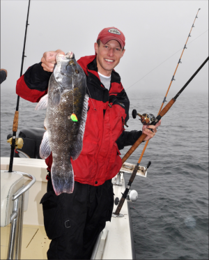 Kevin Blinkoff lifts a big Buzzards Bay tog on a foggy October morning.
