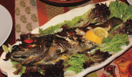 A grilled whole fish isn’t the prettiest dish, so go heavy on the garnish.
