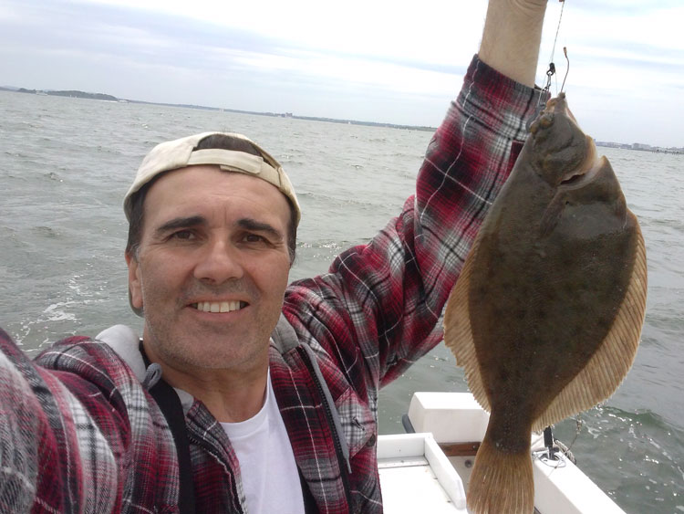 Al Pereira shows off a nice flounder taken off of Deer Island last week.