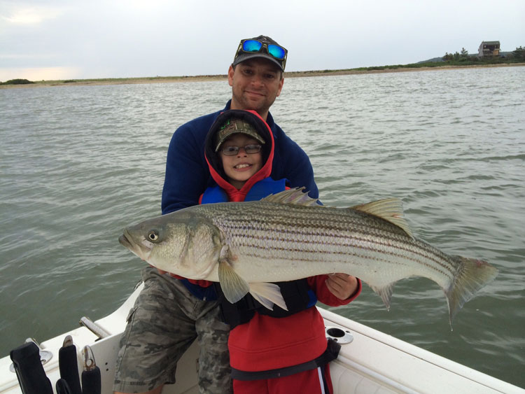 Todd Bernstein and his son, William hold a nice 38 inch fish taken on Mackerel in Plymouth.