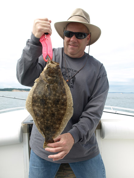 Chief Master Sergeant John with one of several 19-inch plus fluke on the day. He was hi-hook.