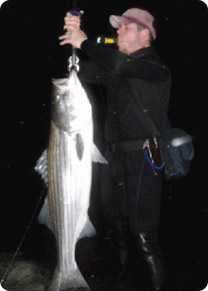 Jimmy Fee checks the weight on a fall run Cape Cod striper.
