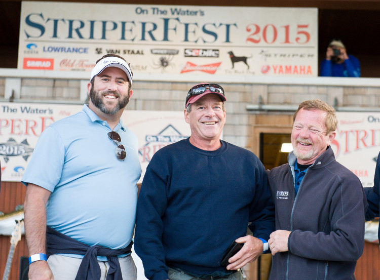 Grand Prize Winner Joe Dyer (center) of Salem, Massachusetts is congradulated by Matthew Ventzer of Striper Boats (left) and Dave Ittner of Yamaha (right). Dyer did not weigh a fish in the tournament this year, but like all entrants, he received a Golden Ticket that, when entered at the annual StriperFest, gave him a shot at winning the tournament's Grand Prize.