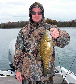 The author&rsquo;s friend, Tom Jones, with a fiesty November smallmouth