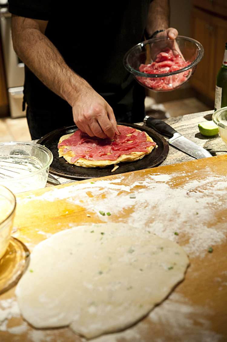 Adding the tuna to the scallion pancake.