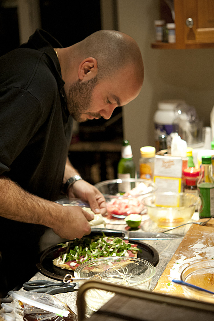 Microgreens and eel sauce put the final touches on the tuna pizza.