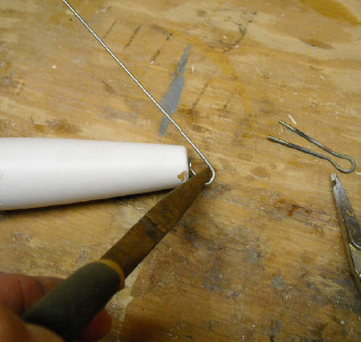 The tail end of the through-wire is bent into shape with needlenose pliers.