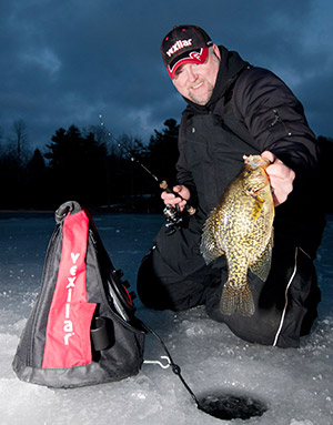 Rob Jackson hoists a hefty crappie he coaxed to bite thanks to his Vexilar flasher.