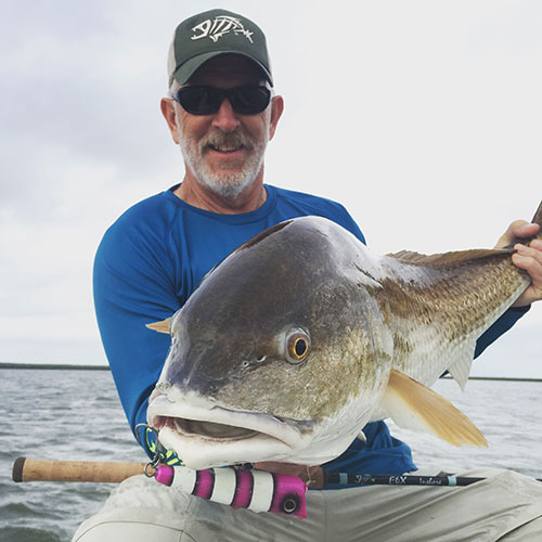 Bruce Holt poses with a big red that smashed a Pop Orca, a topwater lure designed for offshore fish species.