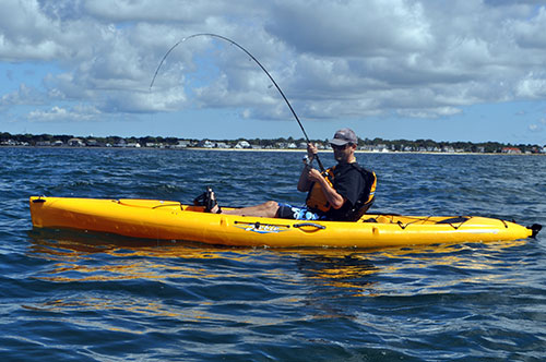 kayaker using rod to fight albie
