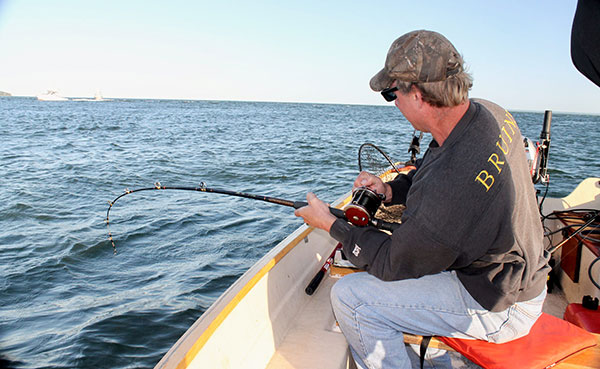 Scott Pedersen puts the boots to a spring blackfish before it can reach the shelter of a rock pile.