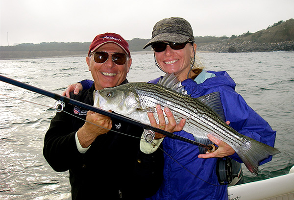 Captain Robin Calitri with a springtime school-sized Western Sound striper.