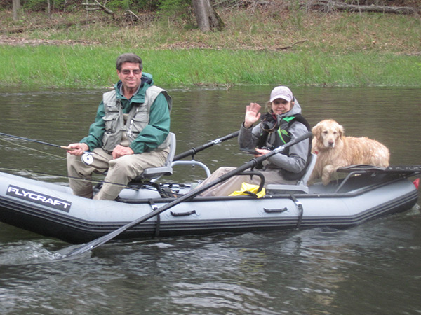 Even dogs like to take the occasional raft trip down Pine Creek! Pictured here is John and Julie Szur with their faithful fishing companion, Brookie.