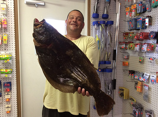 A-happy-John-Foster-of-Jackson-holds-the-9-pound,-13-ounce-fluke-he-weighed-in-at-Fishermen's-Den.