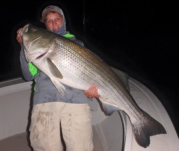 Young angler Max with a trophy bass aboard Reel Cast Charters