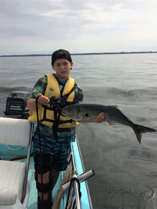 Owen Duvel holds a big bluefish caught from his family's 1964 Whaler.