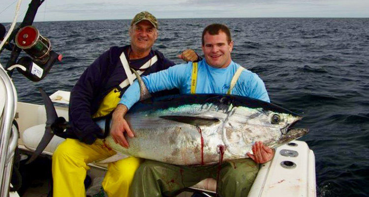 Bill Doherty and Jim Dolan with a 68" tuna taken aboard the T Sea.