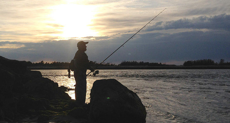 With a running tide and a setting sun, the author begins a productive night of fishing the inlets.