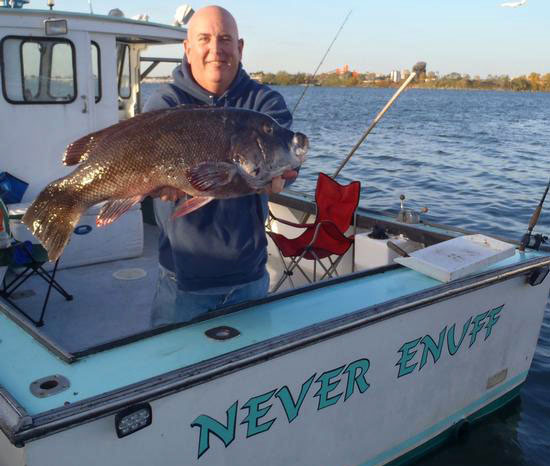 The author displays a monster blackfish caught aboard the Never Enuff.