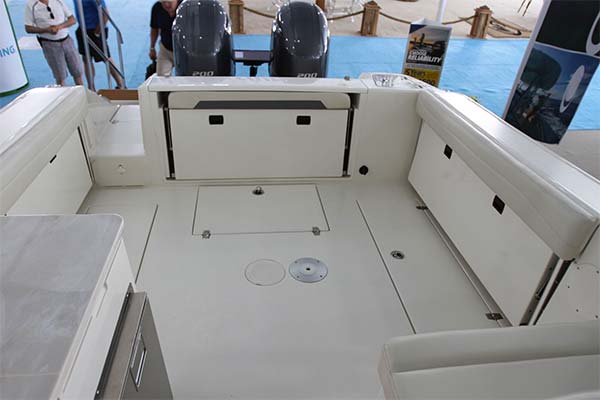 All aft bench seating hides away under hinged covering boards making for a wide open cockpit free of any snags or concerns of damaging the cushions when fishing. Note the standard insulated 47 gallon fishboxes in the floor that can be macerated to pump overboard.
