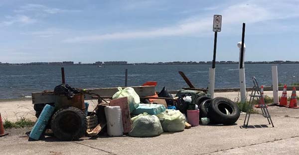 mountain of trash behind our desk at the launch ramp.