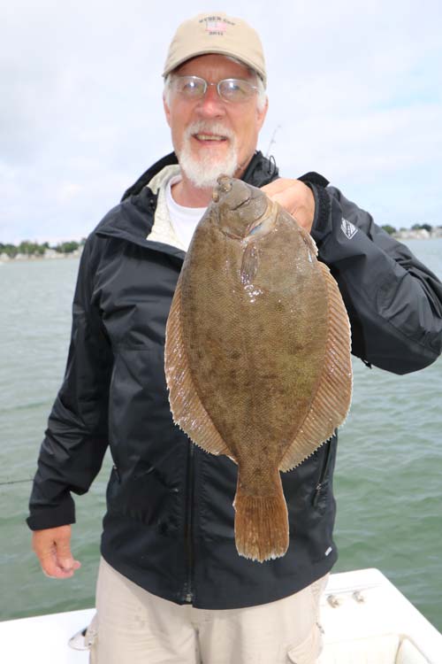 Captain Jason Colby is finding fine flounder such as this one among warmer water sections of Quincy Bay.