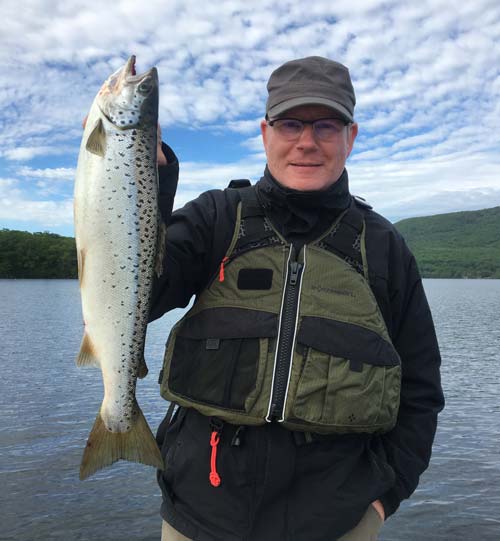 Rolf from Switzerland with one fine 5.9 pound Winnipesaukee salmon he caught while being guided by Tim Moore.