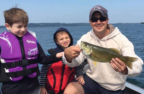 Dad and his boys enjoy summer lake fishing!