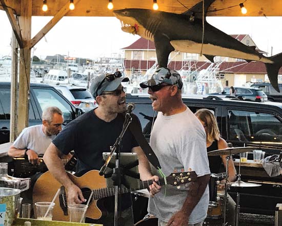 Captain Mark Marose pitches in on vocals at Lynne's Hula Hut