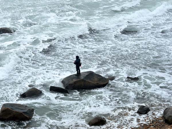 A surfcaster working the South Side rocks.
