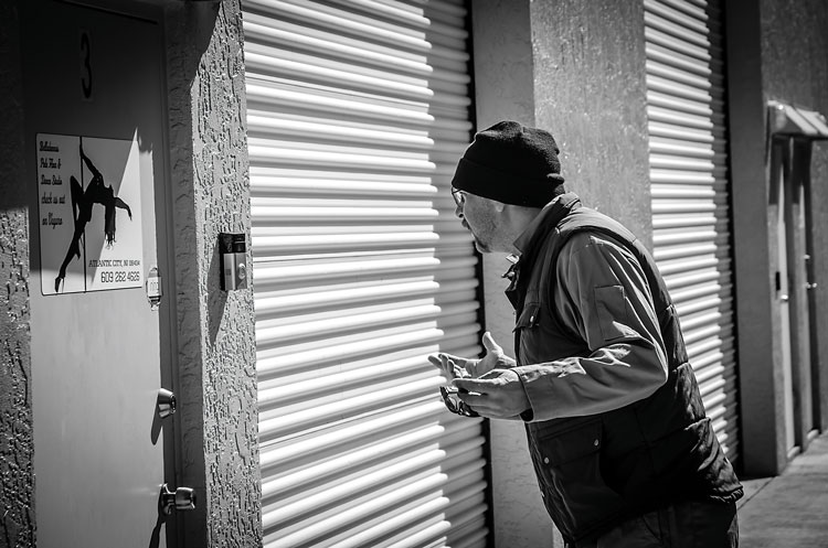 Garbage man outside strip club