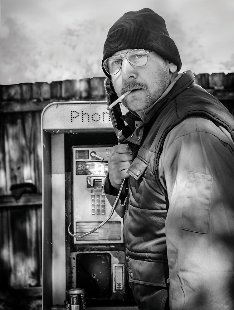 Garbage man on payphone