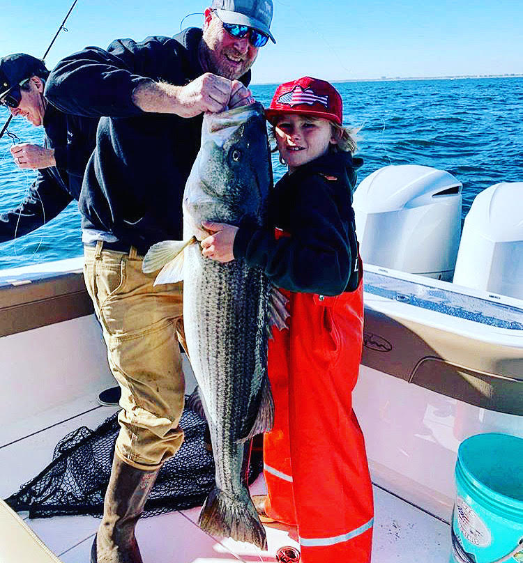 Stone Keating posing with a giant bass he caught all by himself earlier this week.