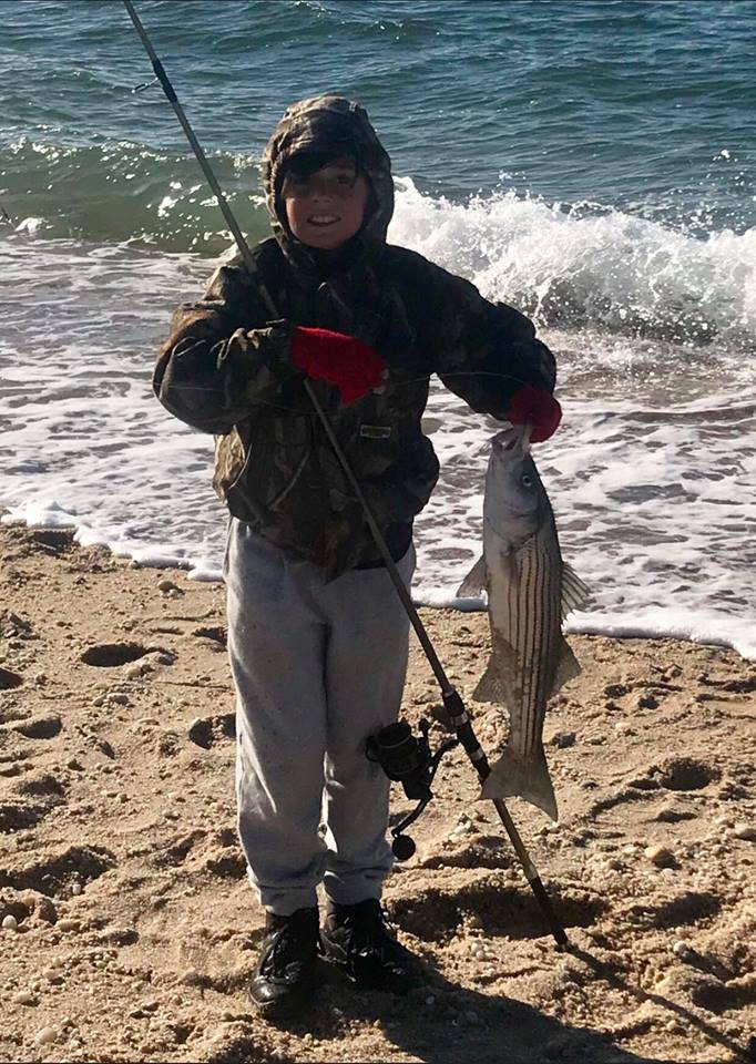 Michael DeNicola with a 26-inch late-season schoolie caught from a North Fork, Long Island beach.