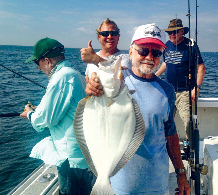 Capt. Pete Sykes gives the thumbs-up as Ed Lepelis holds up one of his three keepers of the day.