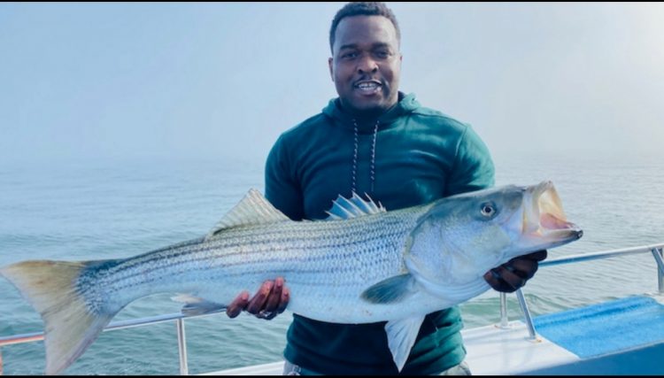 A keeper striped bass caught on Gypsea Charters