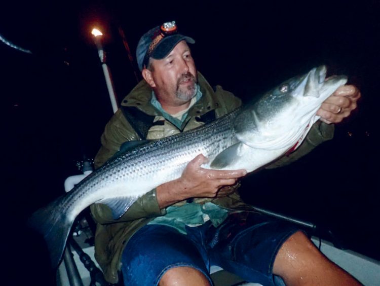 A striper caught in a kayak trolling a tube and worm at night.
