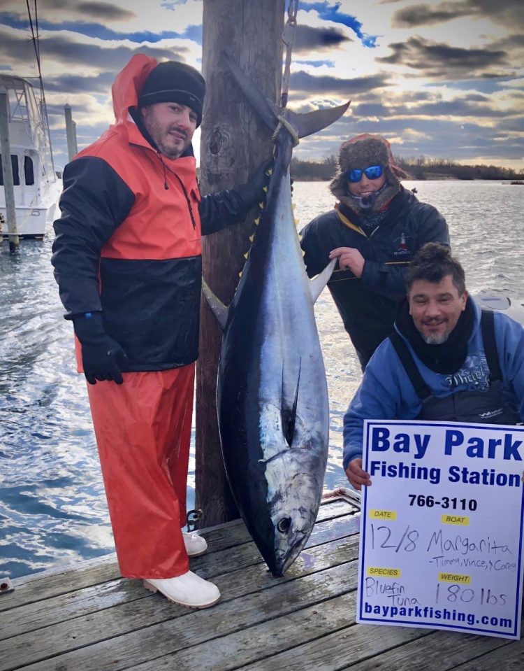 Capt. Tim, Vince, and Cory with a 69-inch, 180-pound bluefin tuna.