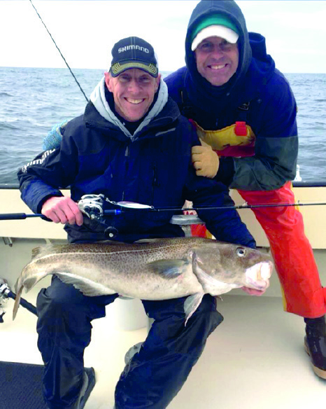 Chris Bielert and Capt. Richard Chatowsky with a 20-pound cod caught using a Shimano jig on Drifter Charters.