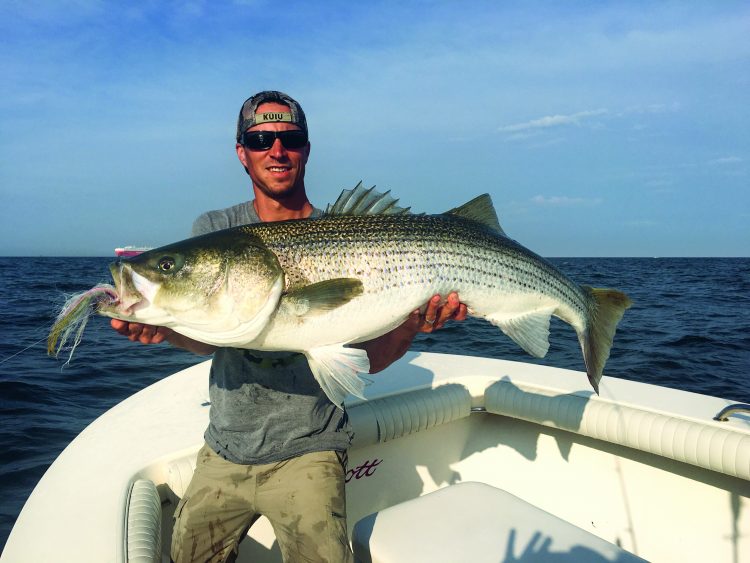 Captain Jason Dapra of Blitz Bound Charters put his client, Jesse, on a 54-pound fly rod striper.