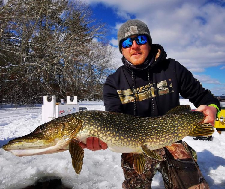 Mike Kelley holds a tournament winning northern pike.
