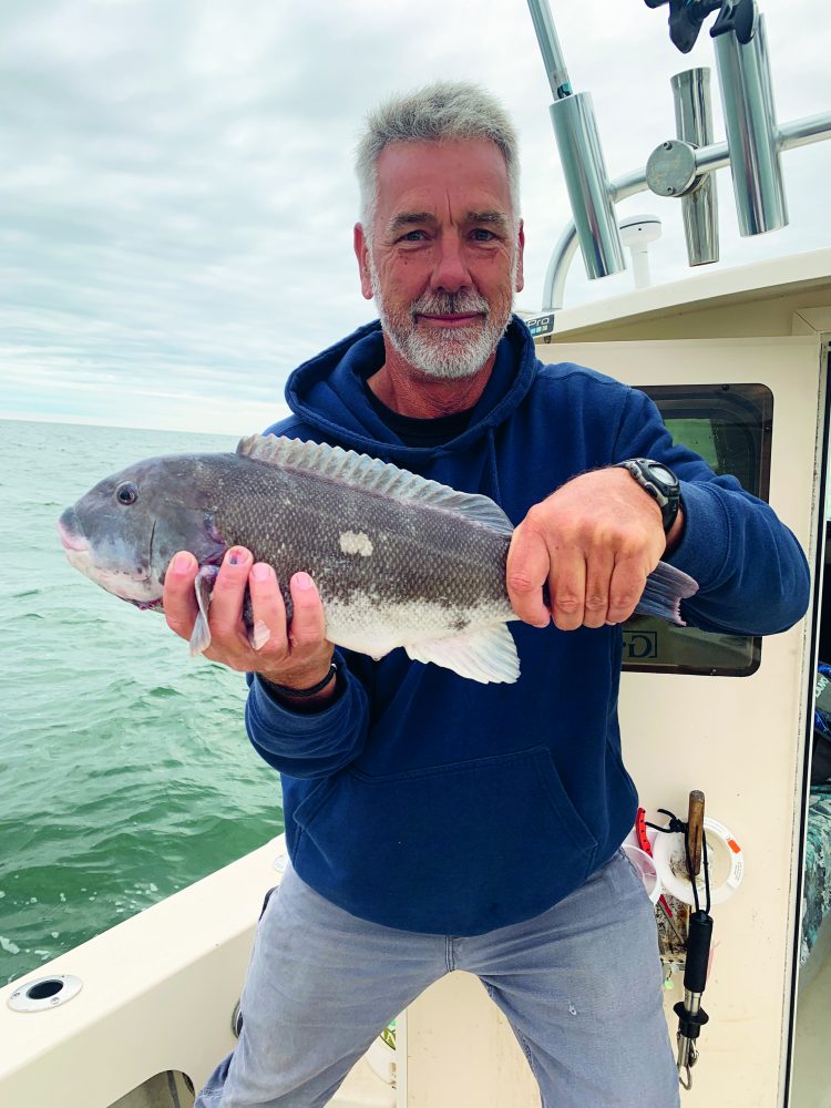 Fisherman holding tautog
