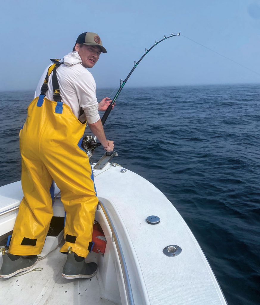 angler with hooked bluefin